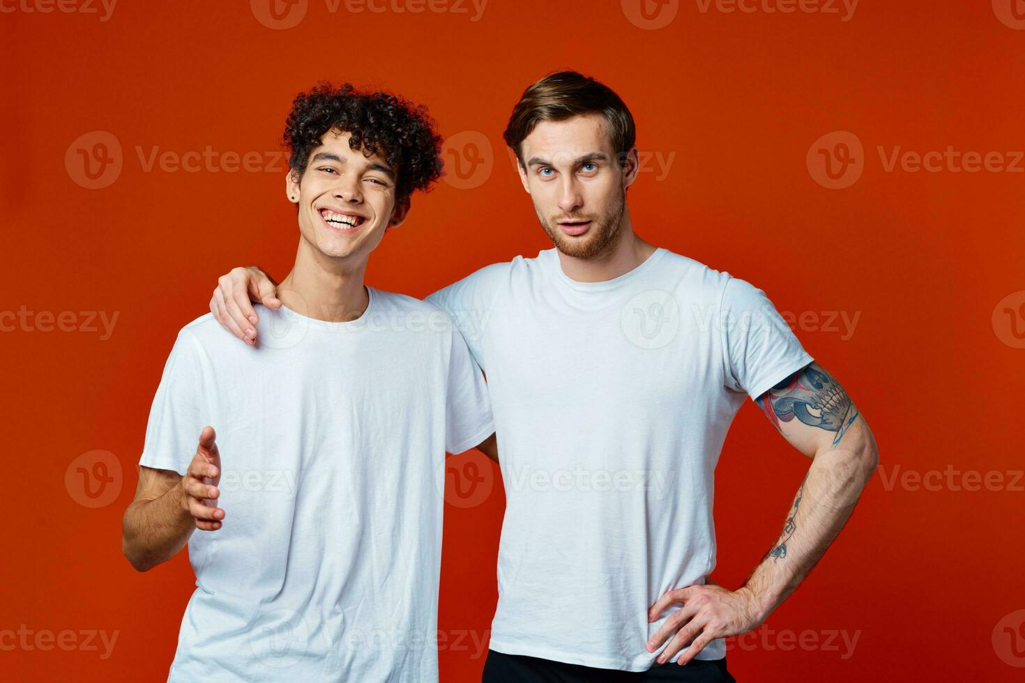 Two cheerful friends in white t-shirts stand side by side photo