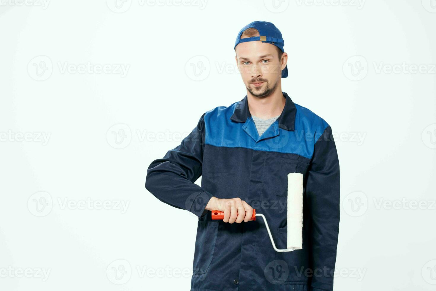 man in work uniform wall painting repair service photo