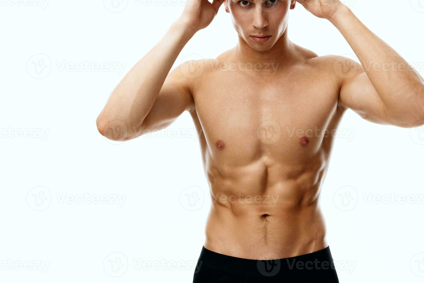 nude athlete with pumped muscles bodybuilding fitness and hands near face cropped view photo