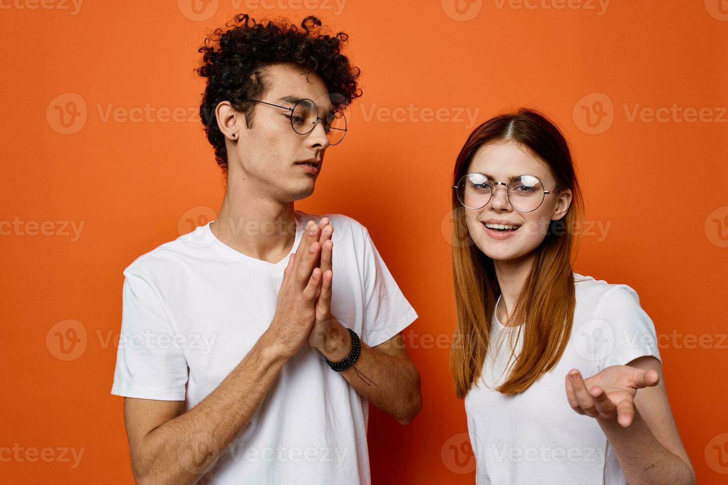 cheerful young couple in white t-shirts in lifestyle fashion emotions communication photo