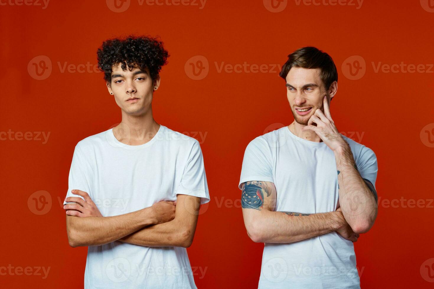 two friends in white t-shirts communication lifestyle red background photo
