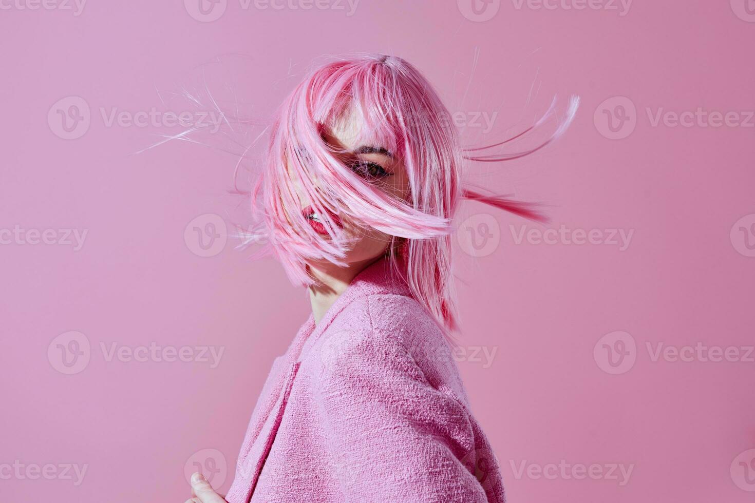 Beautiful fashionable girl pink jacket holding hair cosmetics color background unaltered photo