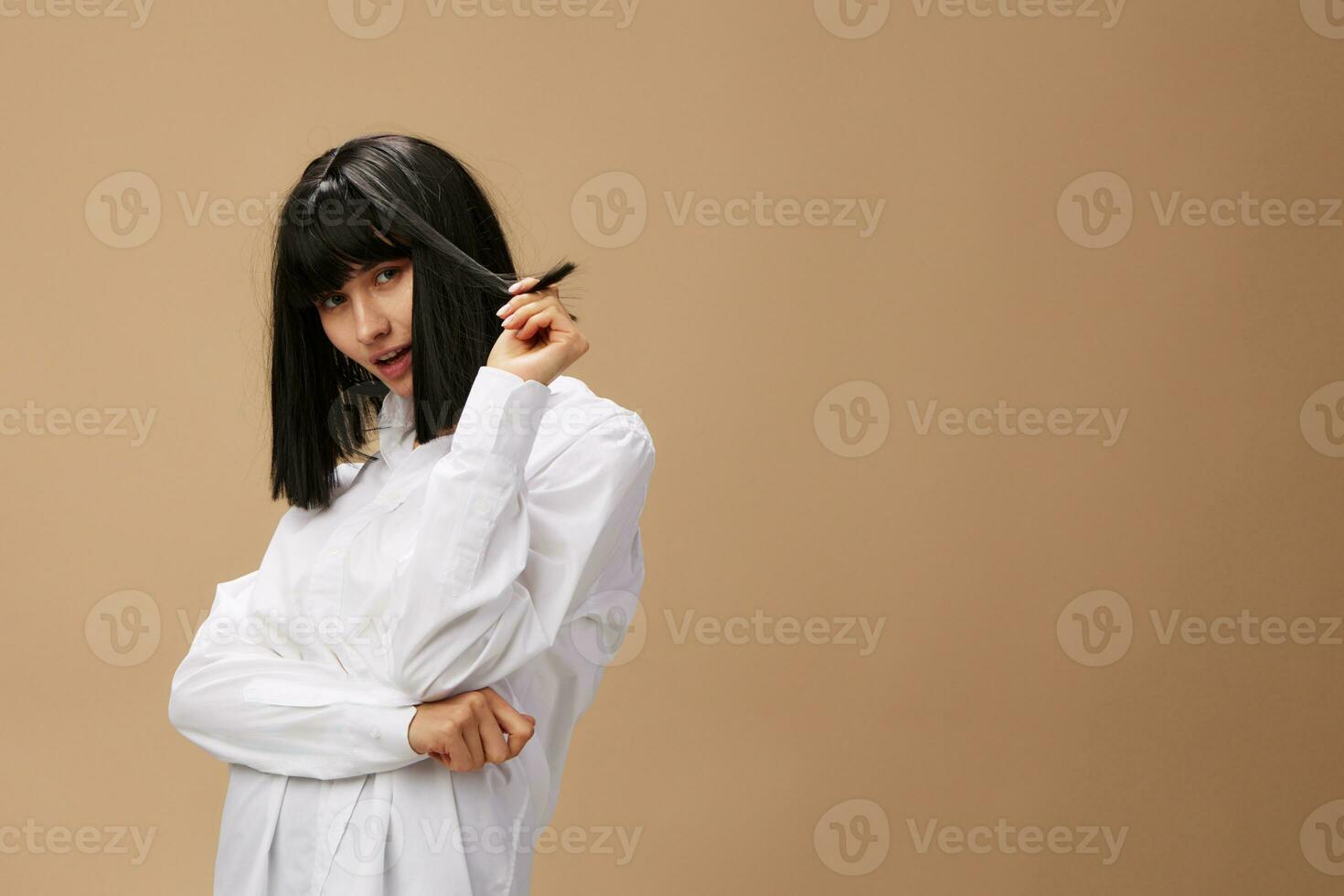 Pretty sexy beautiful stylish adorable brunet lady in white shirt posing isolated on pastel beige studio background. Copy space Banner Offer. Pulp Fiction concept. Fashion Cinema photo