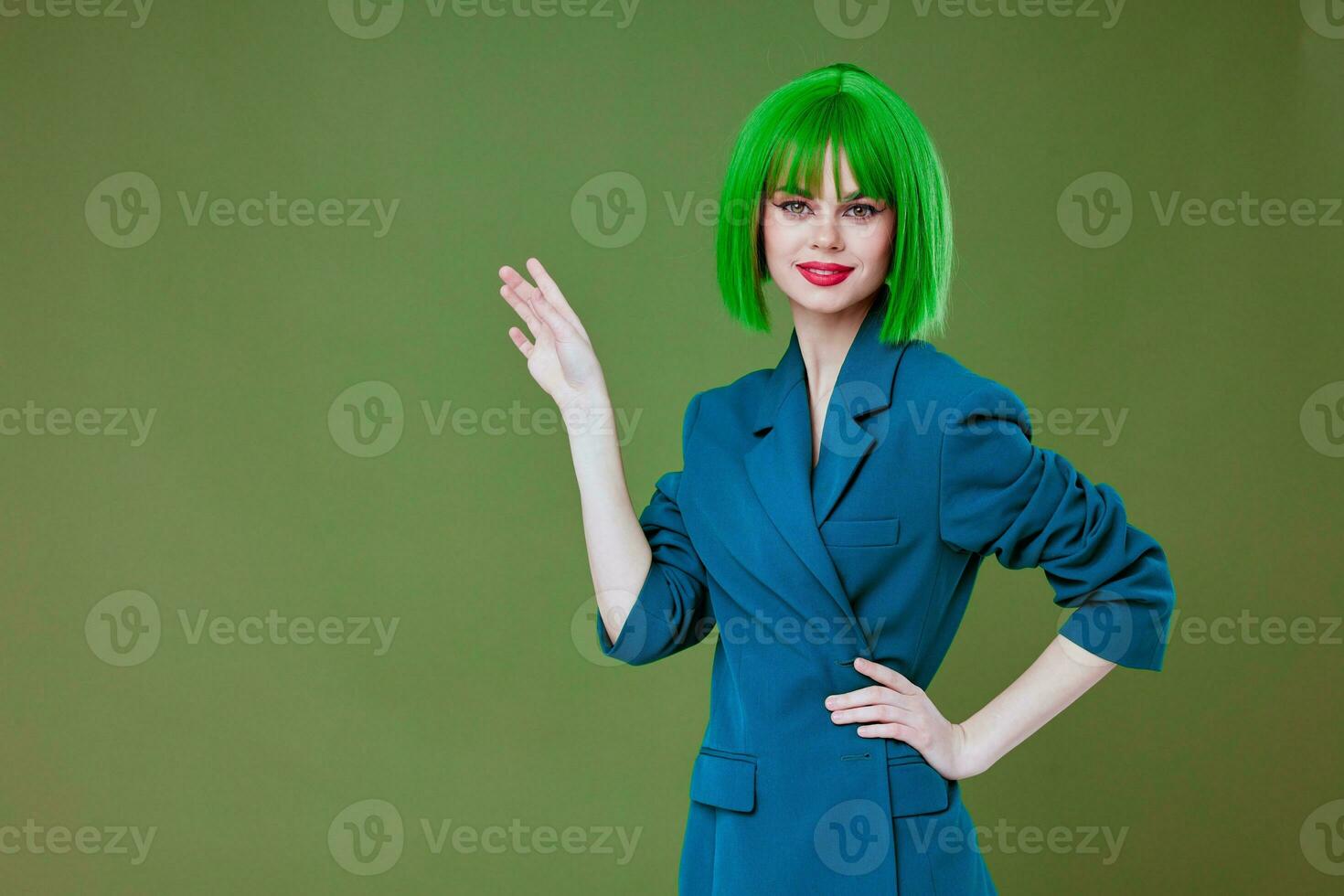 Beautiful fashionable girl attractive look green wig blue jacket posing studio model unaltered photo