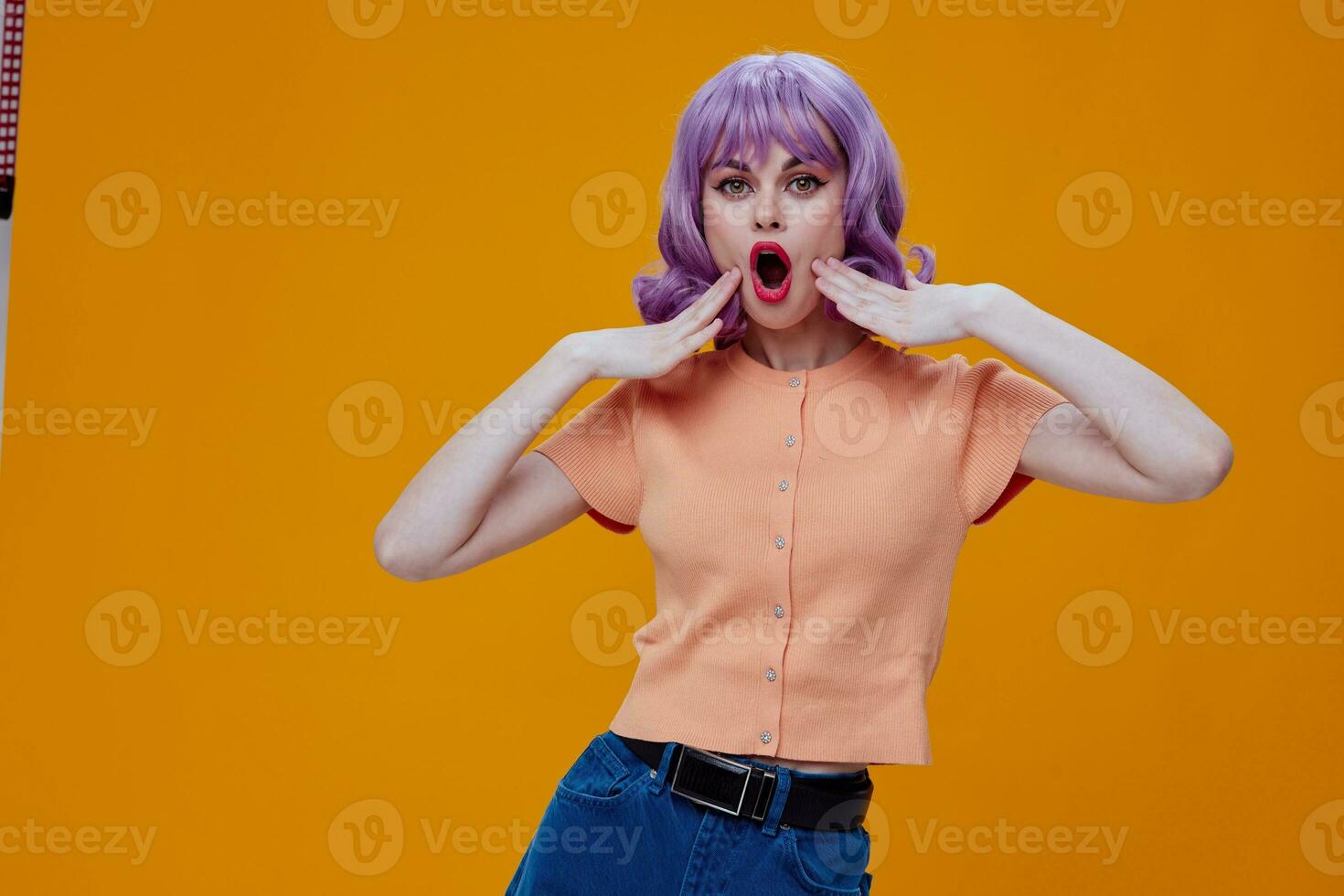 Pretty young female hand gestures purple hair fashion clothes yellow background unaltered photo