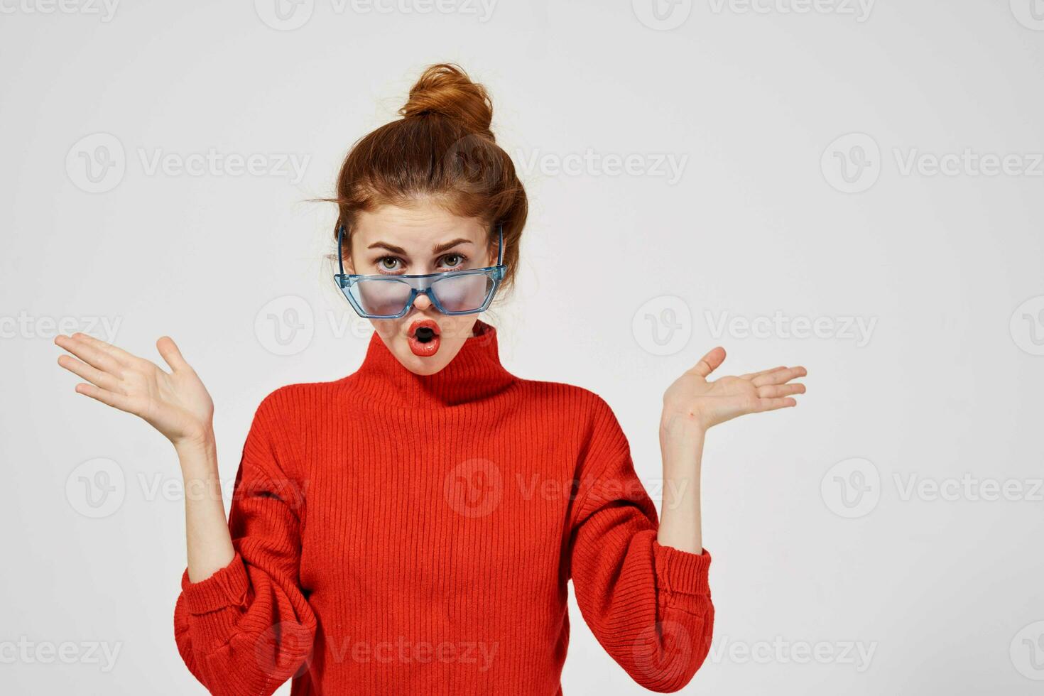 portrait of a woman fashionable blue glasses posing light background photo