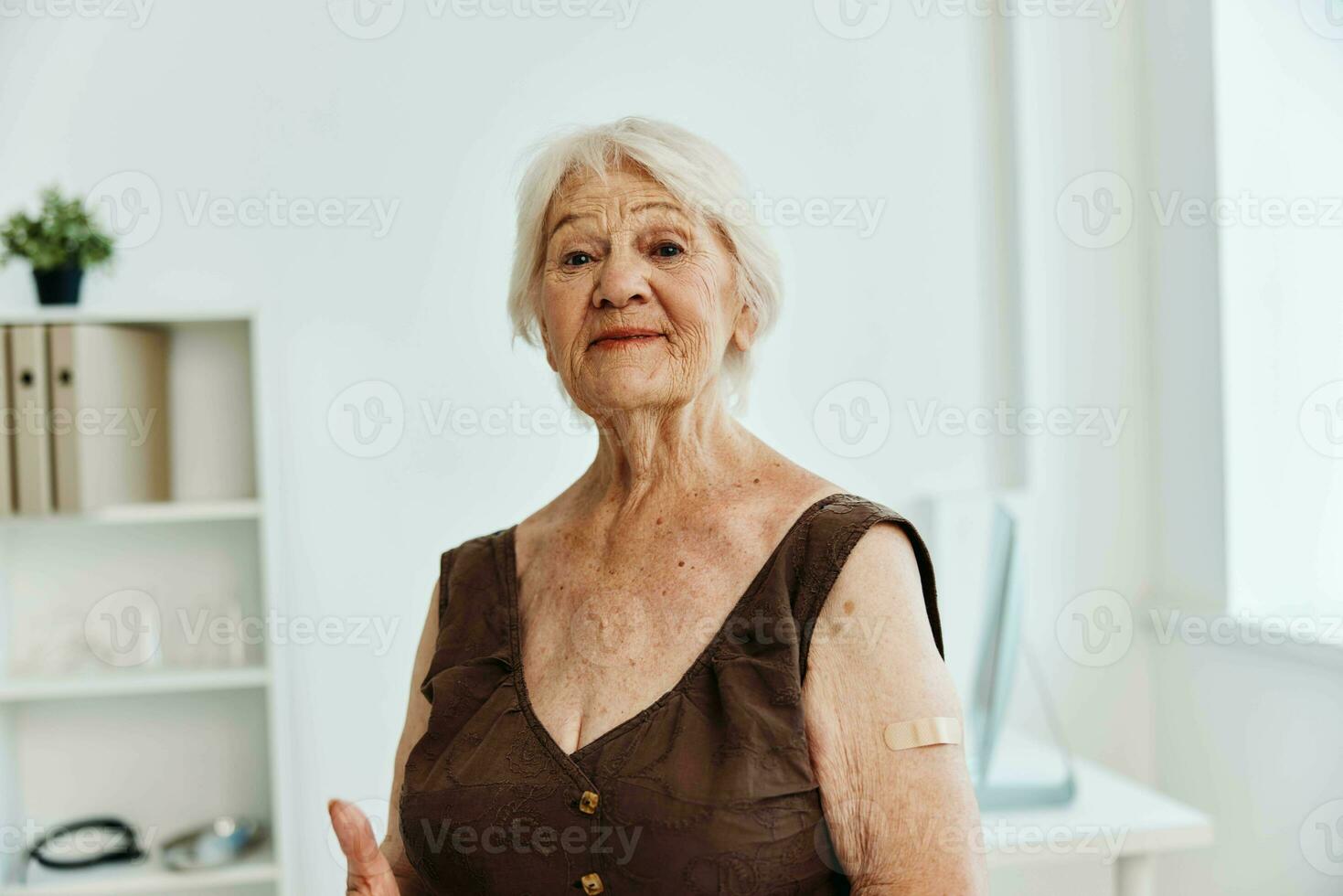 old woman with plaster on shoulder vaccine passport covid-19 photo