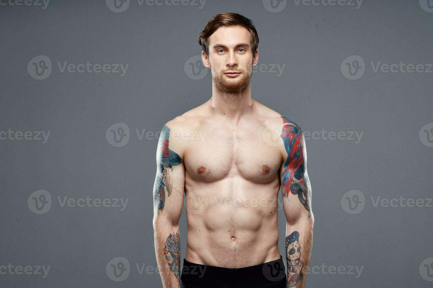 pumped up nude torso men tattoos close-up exercise photo