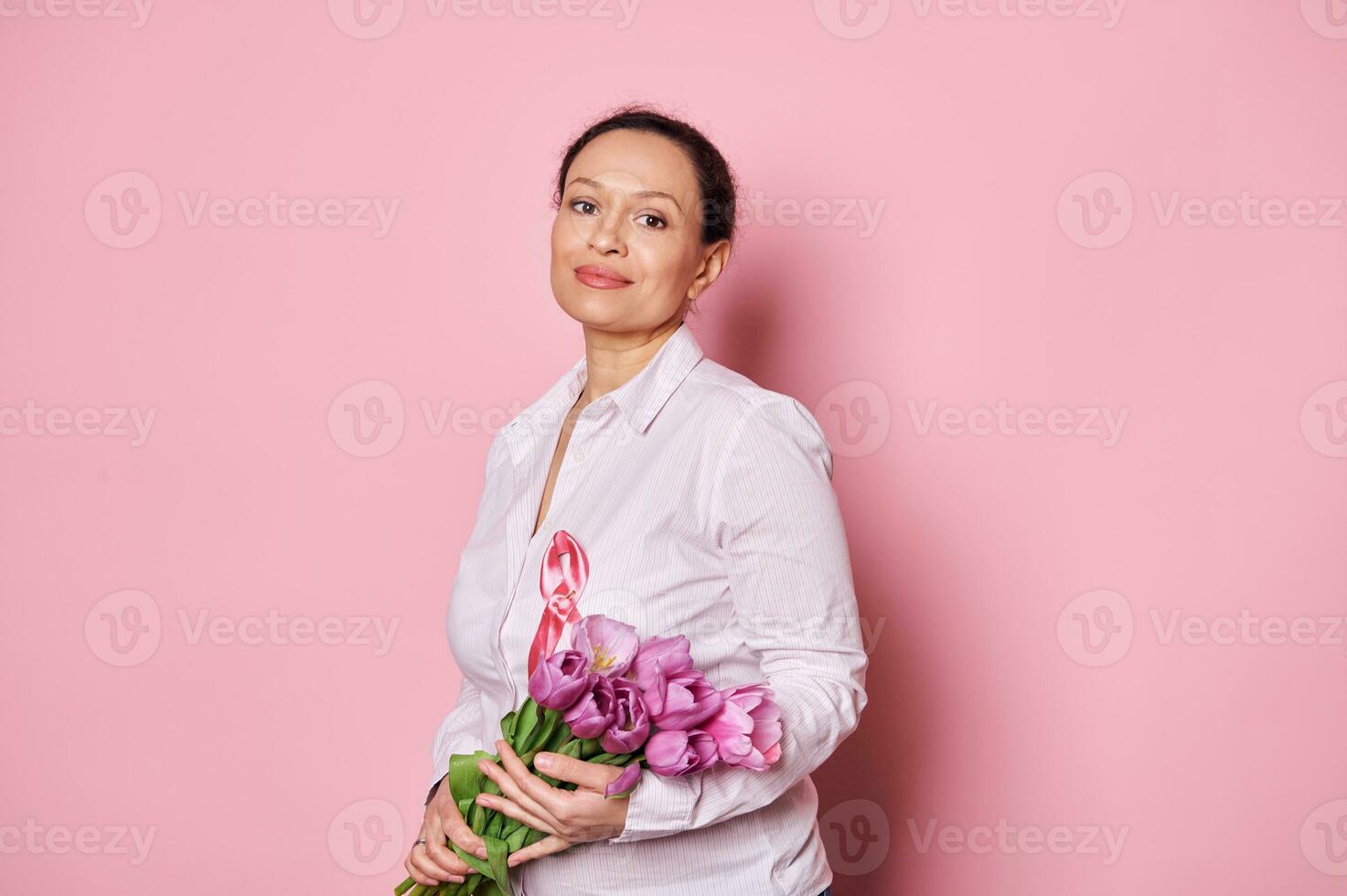 Pretty woman with pink satin ribbon, shows support for cancer patients, survivors. October Breast Cancer Awareness Month photo