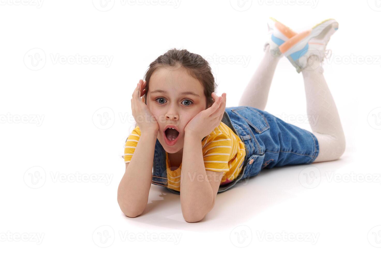 girl mouth Amazed little child girl with open mouth, lying on her belly over isolated white background. Schoolchild portrait 23731562 Stock Photo at Vecteezy