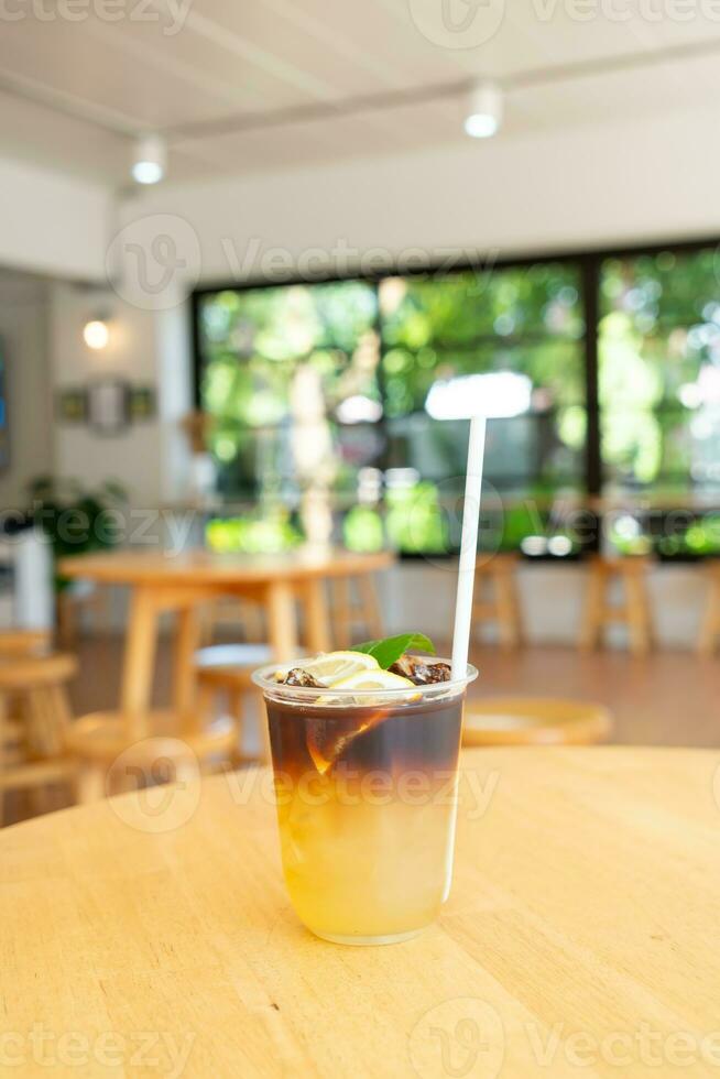 lemon with black coffee in glass photo