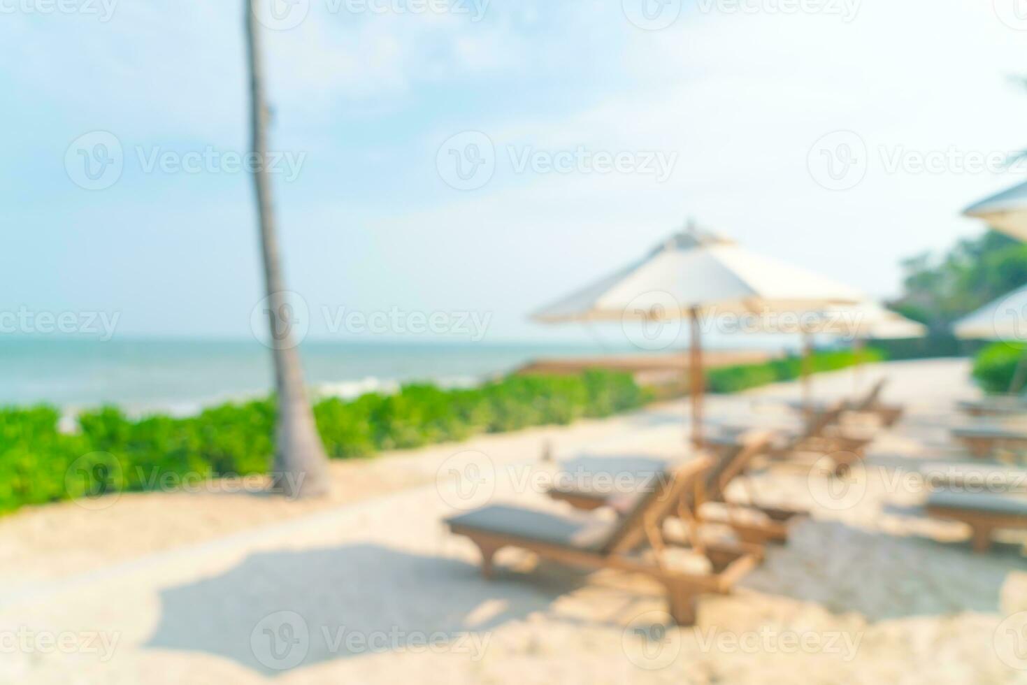 abstract blur umbrella with beach chair for background photo