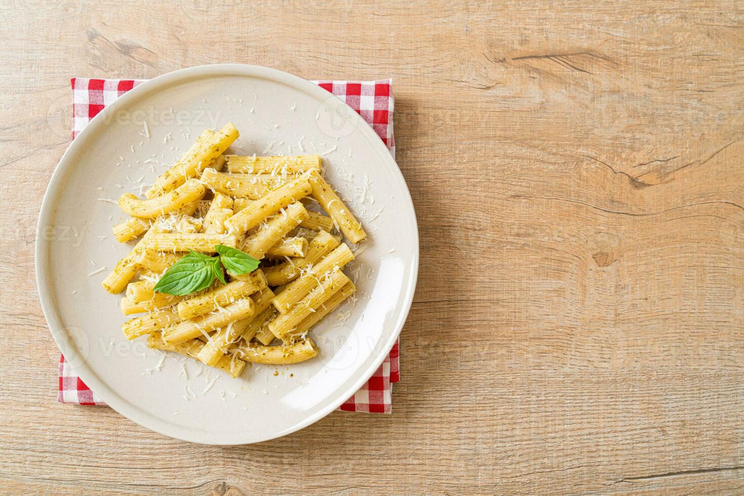 pesto rigatoni pasta with parmesan cheese 23732802 Stock Photo at Vecteezy