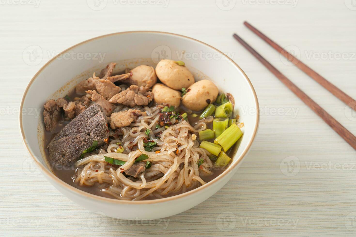 Thai noodle with pork, stewed pork, meatball and pork liver in blood soup photo