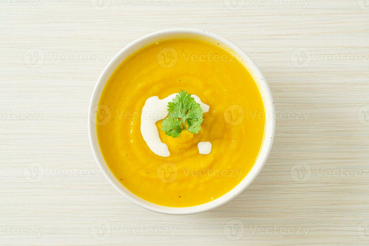 pumpkin soup in white bowl photo