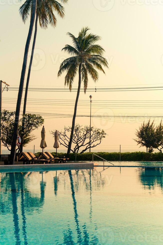 umbrella with bed pool around swimming pool with ocean sea background photo