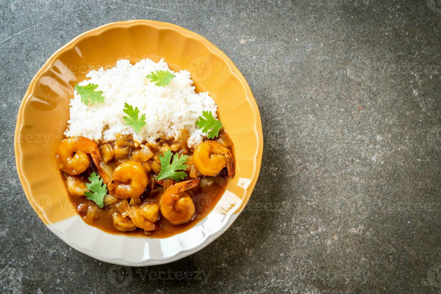 Shrimps in curry sauce on rice photo