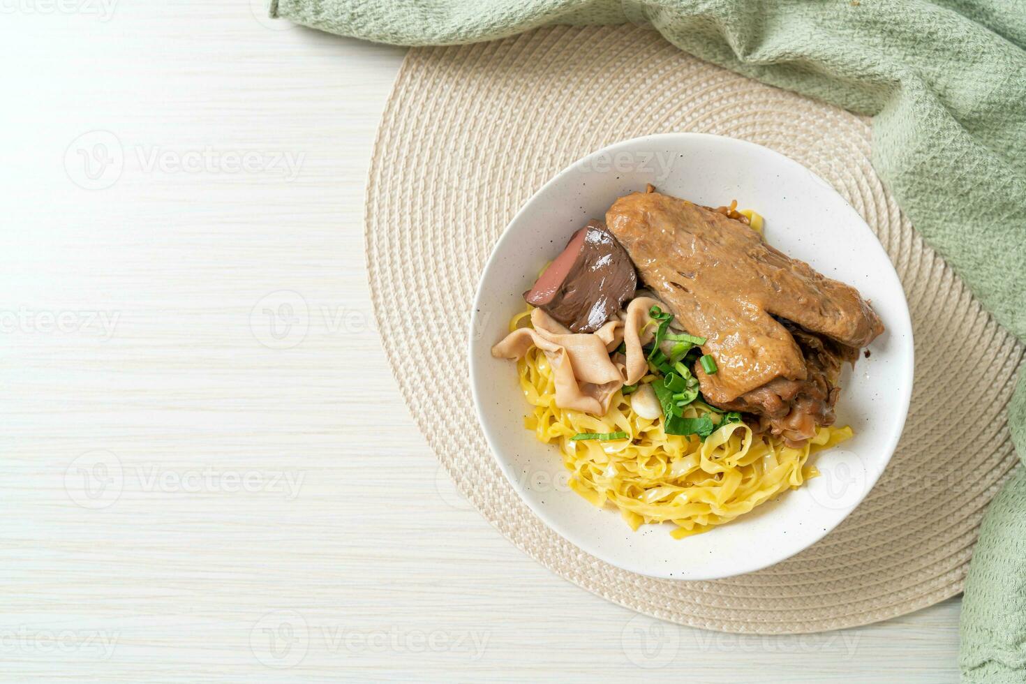 Egg noodles served dry with braised duck photo