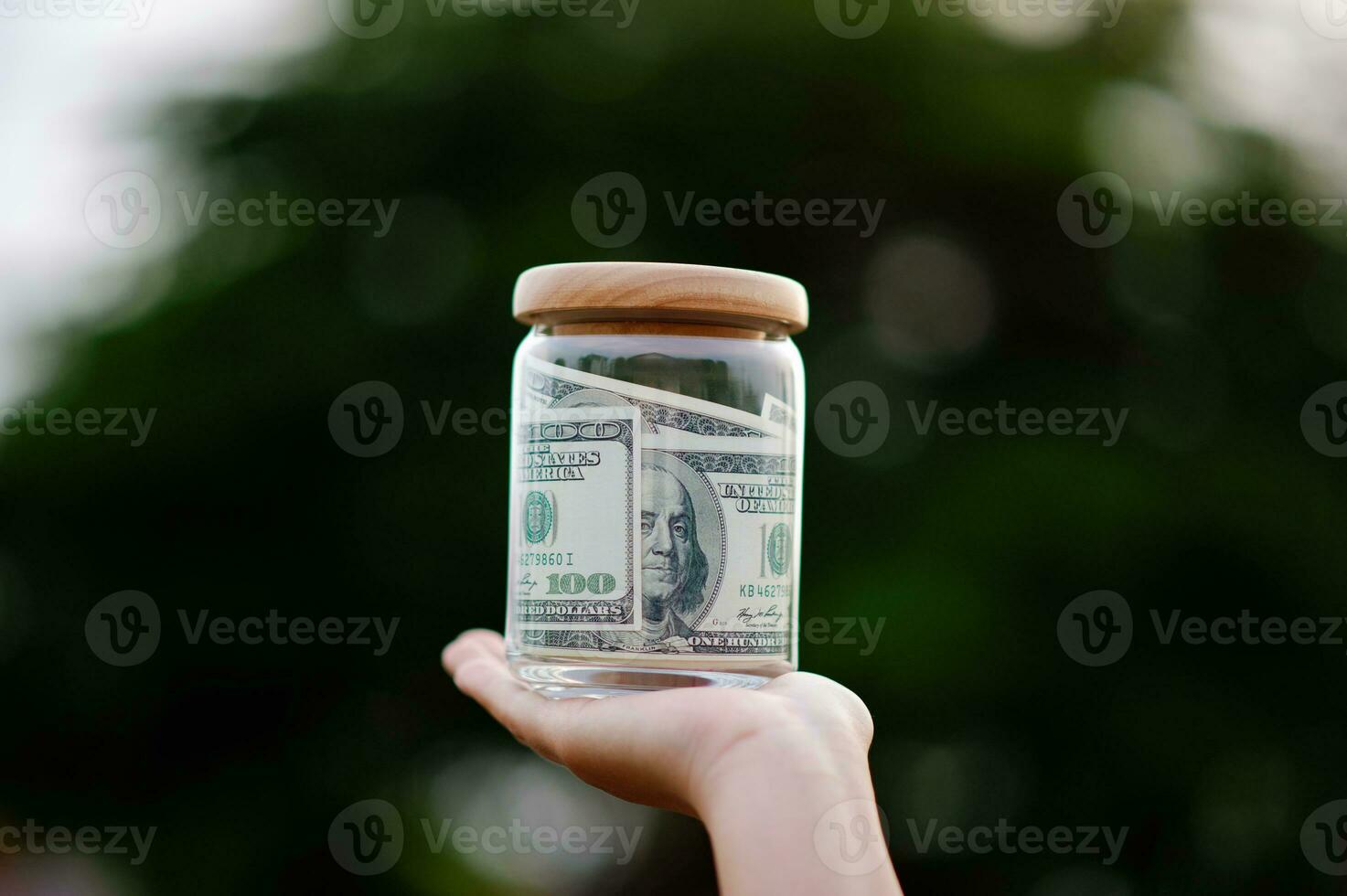 dollar bills in glass bottles Saving money in a glass jar, earnings, income, expenses, profits, financial success financial security photo