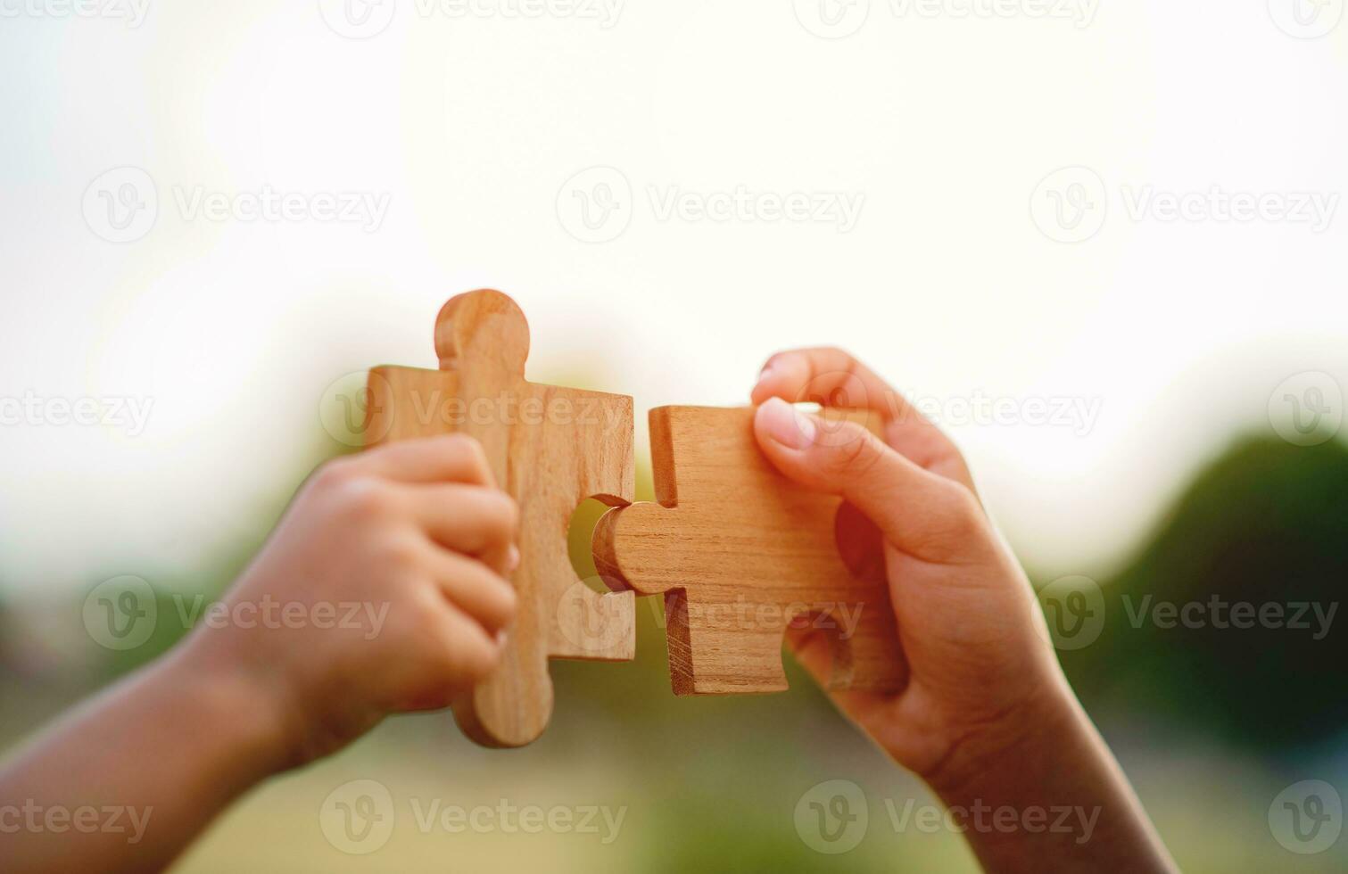 jigsaw in hand puzzle pieces gather together teamwork The concept of planning work as a team. photo