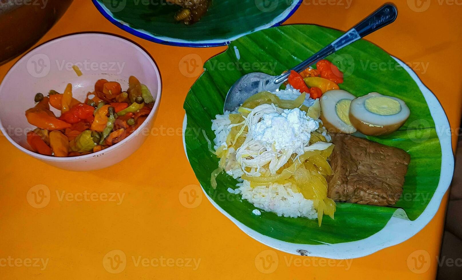 Indonesian food Liwet Rice. A Traditional javanese Rice Served with Chicken, Tofu, Tempeh, vegetable, Chili and Broad Beans photo