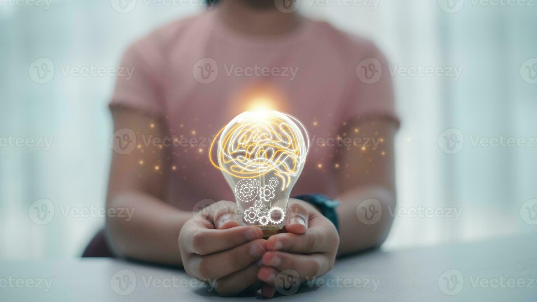Light bulb with a brain inside the hands of the woman. The concept of the business idea concept. photo
