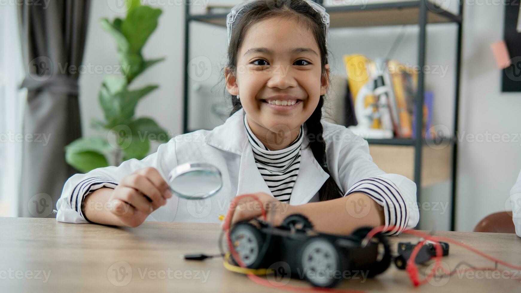 Asian students learn at home in coding robot cars and electronic board cables in STEM, STEAM, mathematics engineering science technology computer code in robotics for kids concept. photo