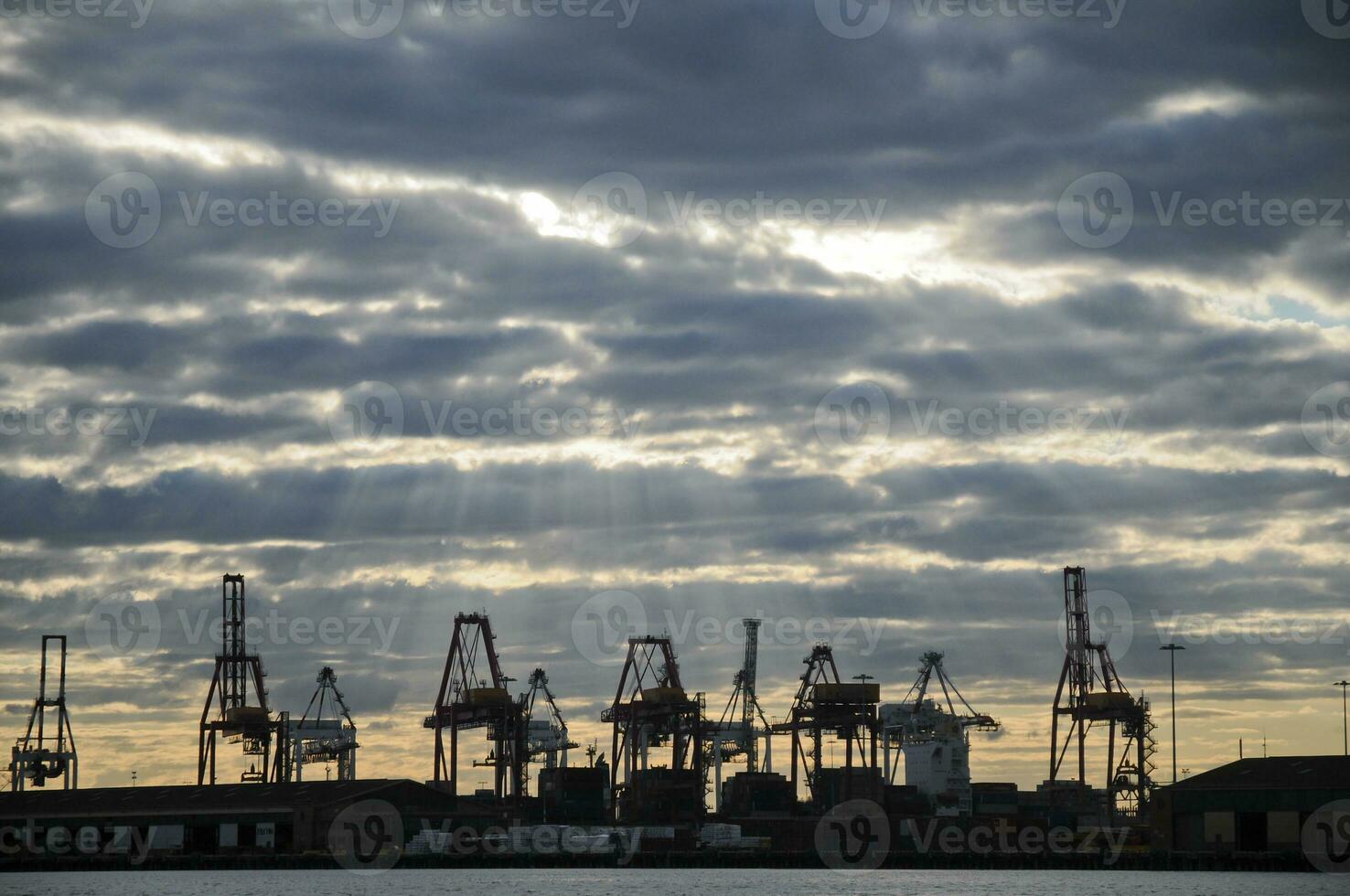 Heavy industry cranes in logistic bay area in the evening twilight scene photo