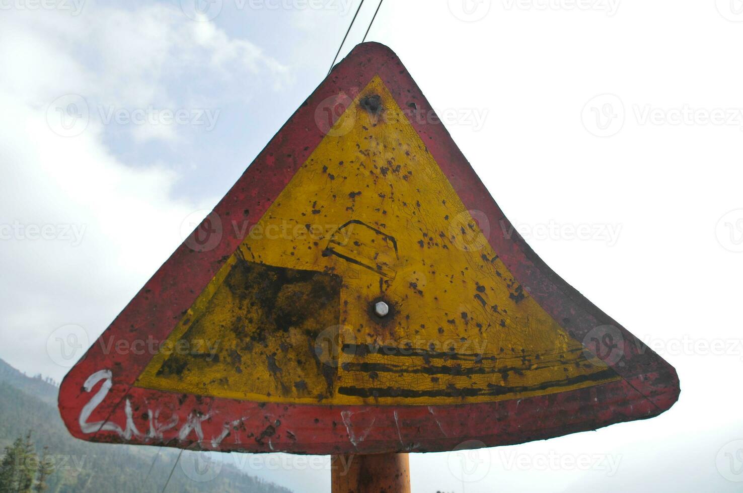 Traffic warning sign for road slippery hazard photo