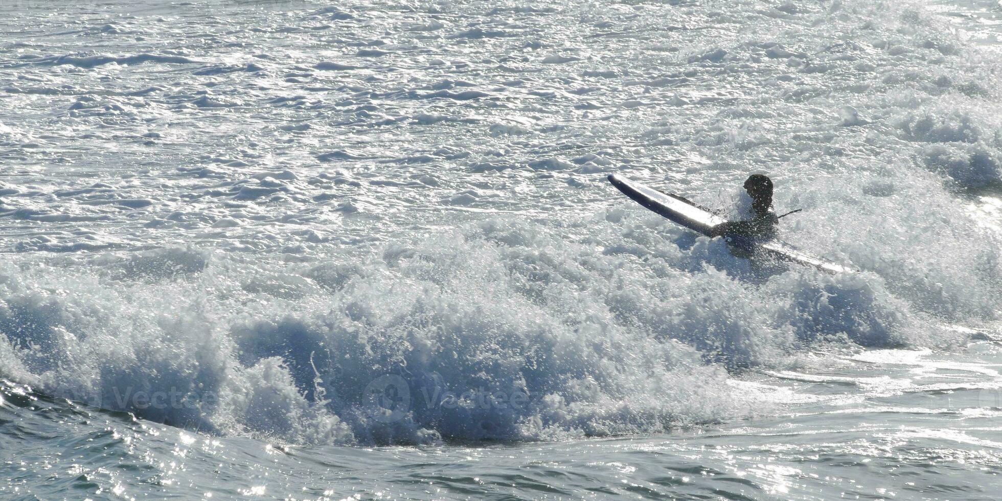 Surfer and the dramatic wave at Bondi Beach Sydney Australia photo