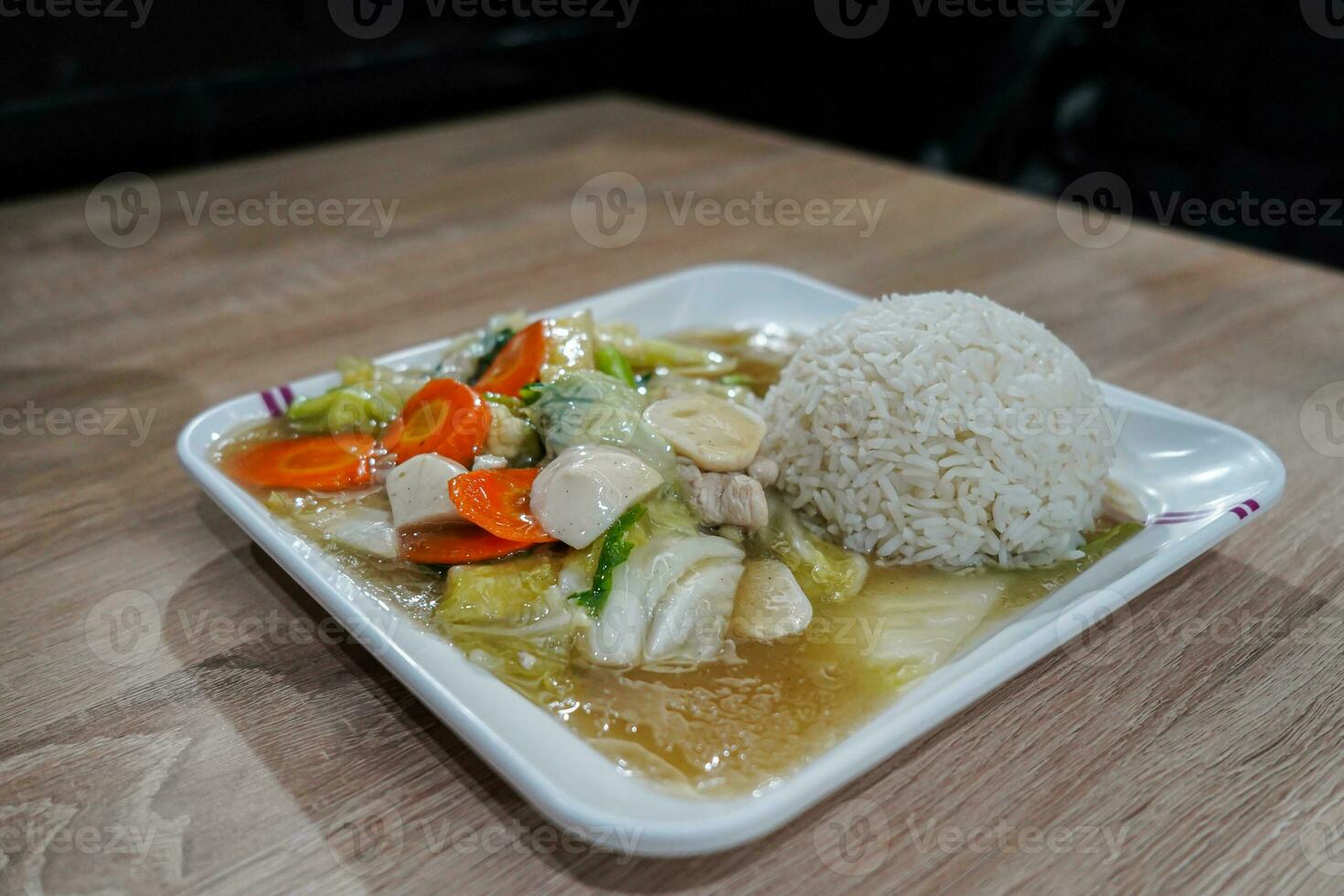 Capcai or CapCay, is a popular Chinese and Peranakan stir-fried vegetable dish. Various vegetables, meatballs, mushrooms, served with white rice photo