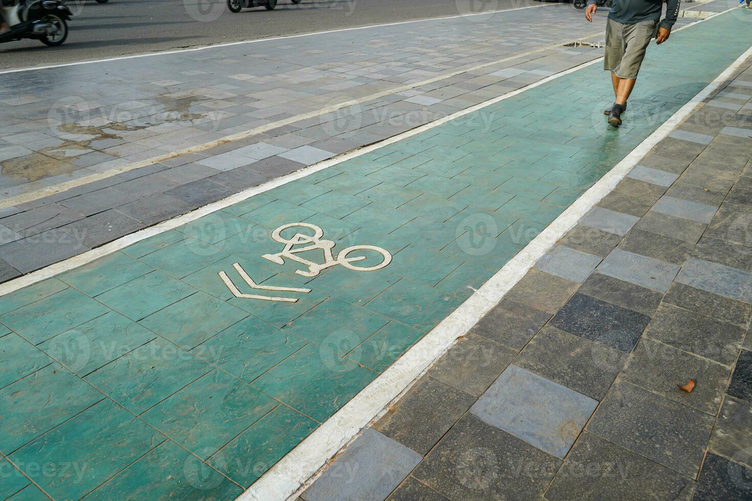 bicycle lane, traffic, city transportation and eco-friendly concept, green bicycle lane with bicycle signs photo