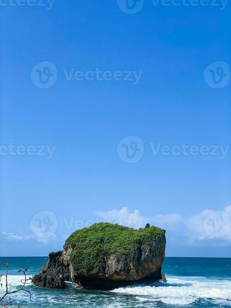 waves splashing on the rocks by the sea, in mesra beach photo