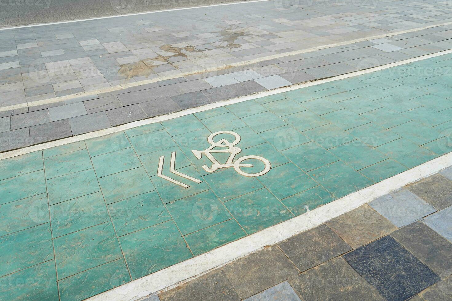 bicycle lane, traffic, city transportation and eco-friendly concept, green bicycle lane with bicycle signs photo