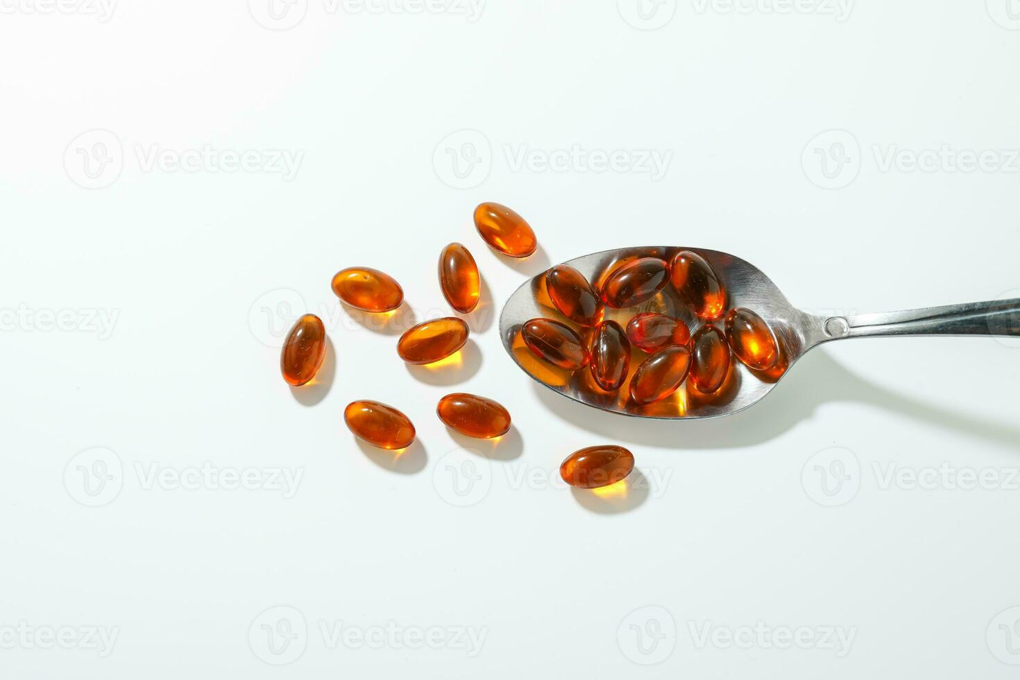 softgel in a spoon, Close up of oil filled capsules, suitable for presenting food supplements, fish oil, omega 3, omega 6, omega 9, vitamin A, vitamin D, vitamin D3, vitamin E, evening primrose oil, photo