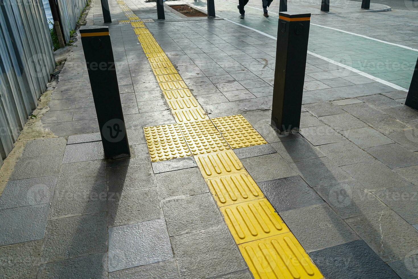 Pedestrian paths, Braille block in tactile paving for the blind handicapped in tiled pathways, paths for the blind. photo