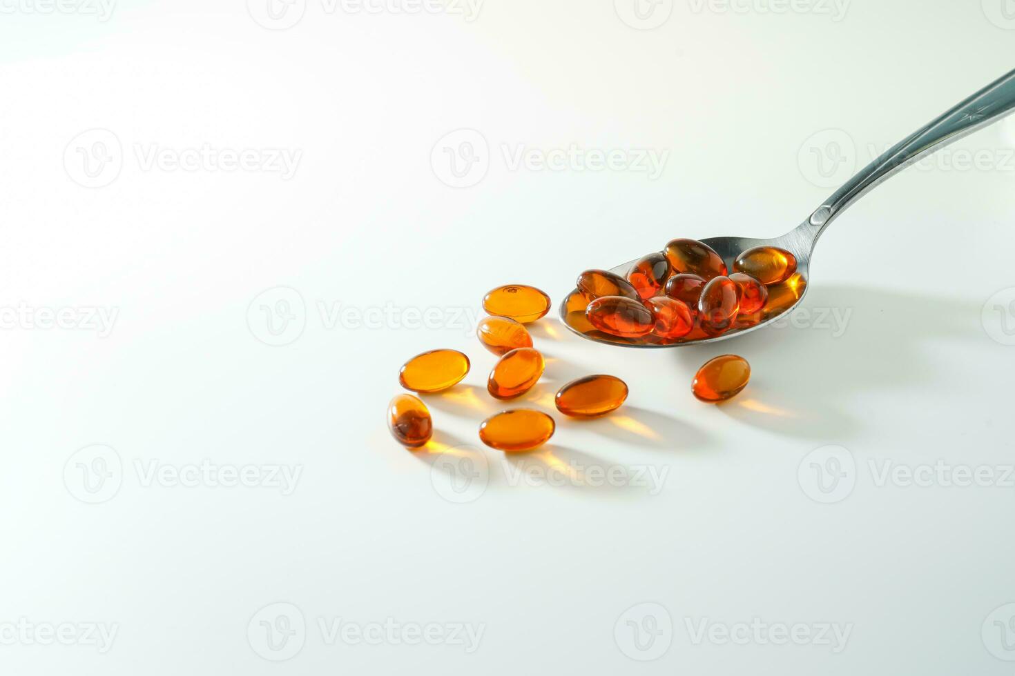 softgel in a spoon, Close up of oil filled capsules, suitable for presenting food supplements, fish oil, omega 3, omega 6, omega 9, vitamin A, vitamin D, vitamin D3, vitamin E, evening primrose oil, photo