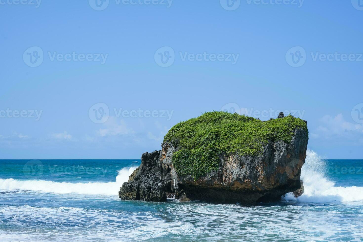 waves splashing on the rocks by the sea, in mesra beach photo