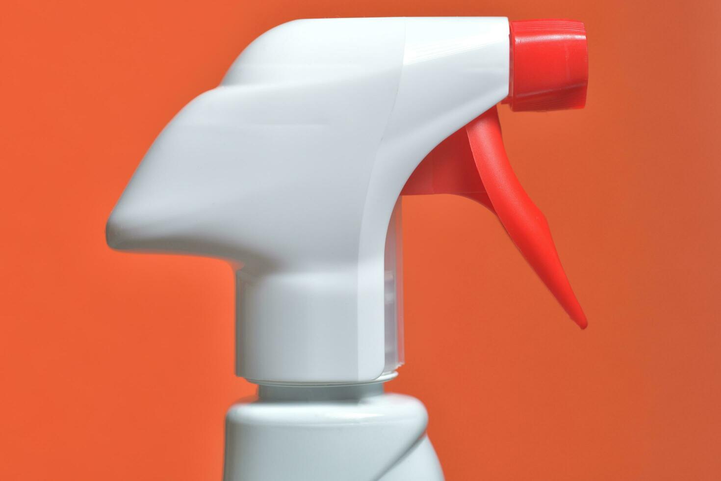 Close view of disinfection bottle isolated on orange background photo