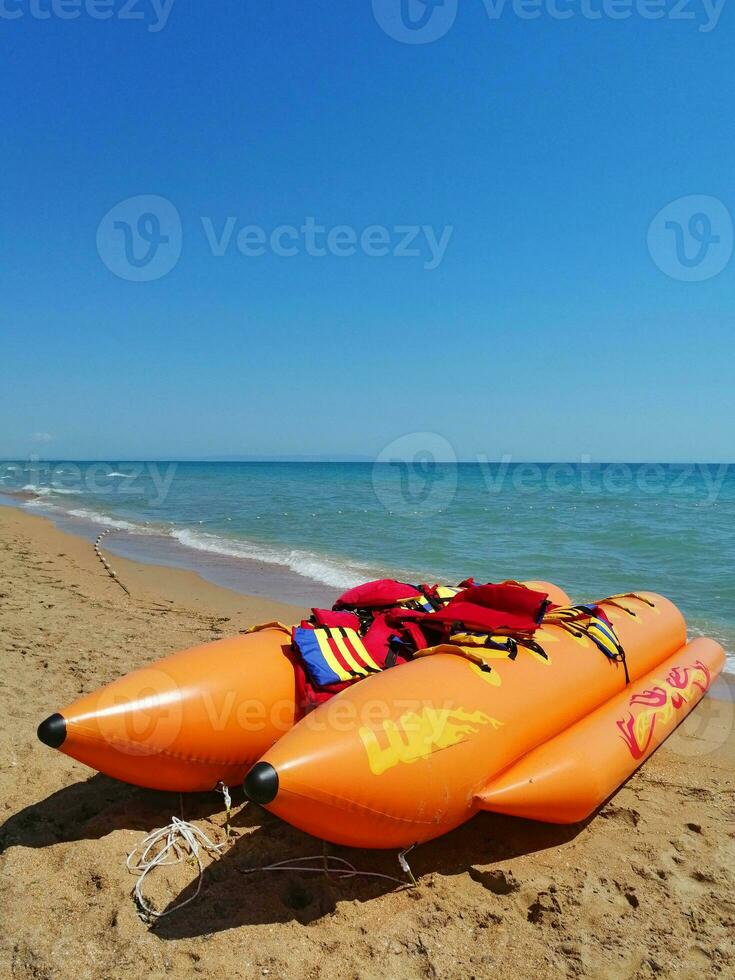 sea attraction. inflatable banana boat on the beach photo