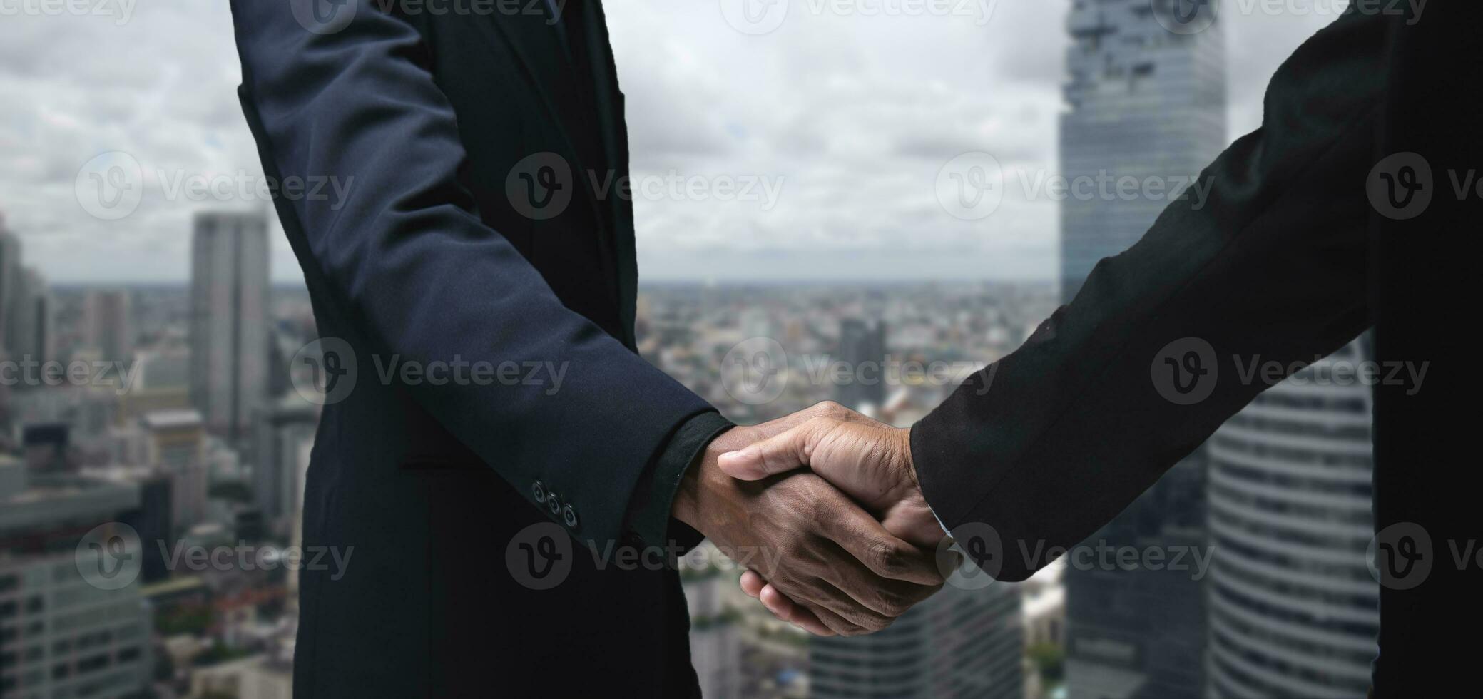 Business partners shaking hands, company CEO and finance manager meeting in city office Business people come to discuss real estate purchase projects and marketing. photo