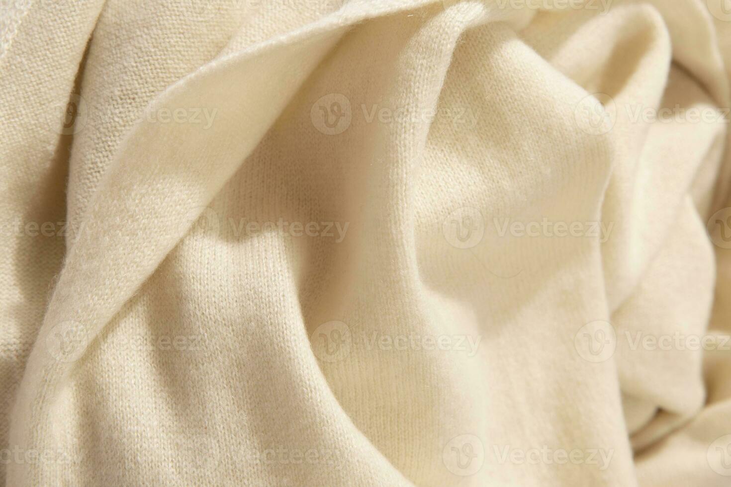 Natural wool yellow colored fabric. Cashmere, wool. Texture of natural wool fabric. Knitwear. photo