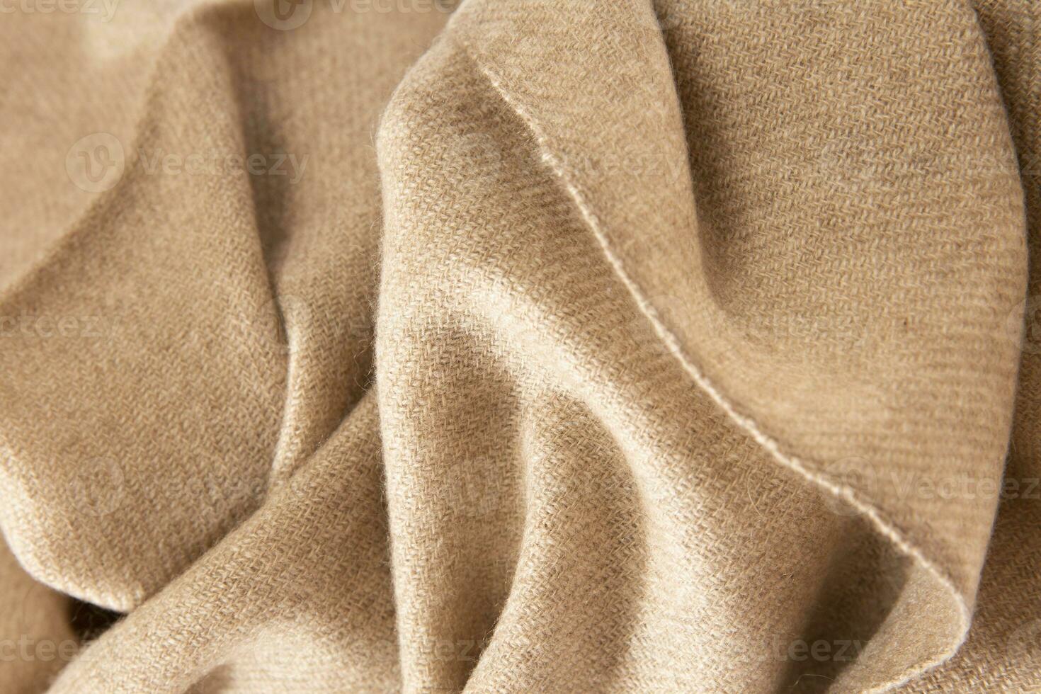 Natural wool beige fabric. Cashmere, wool. Texture of natural wool fabric. Knitwear. photo