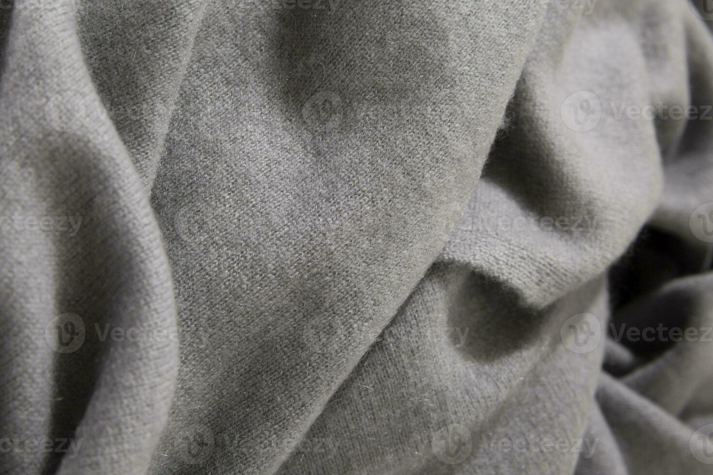Natural wool grey colored fabric. Cashmere, wool. Texture of natural wool fabric. Knitwear. photo