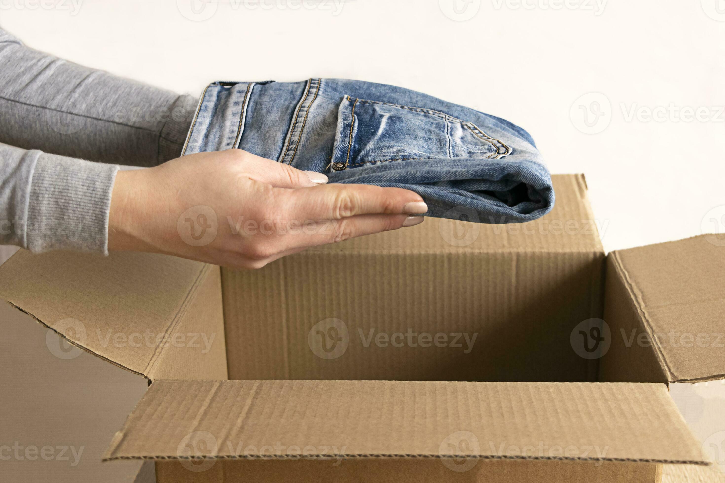 Woman packs clothes in boxes for donating. 23746043 Stock Photo at Vecteezy