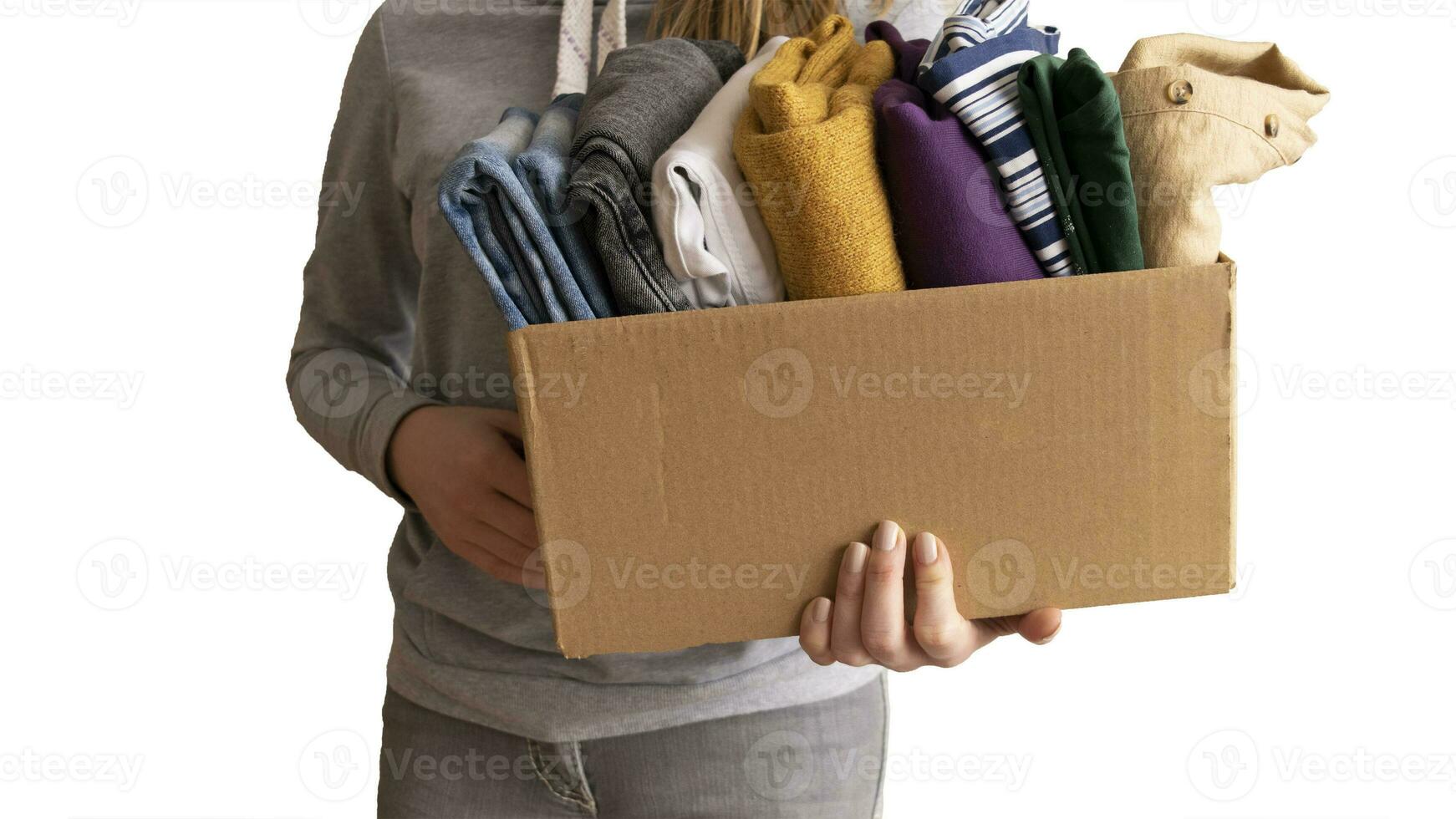 Woman packs clothes in boxes for donating. photo