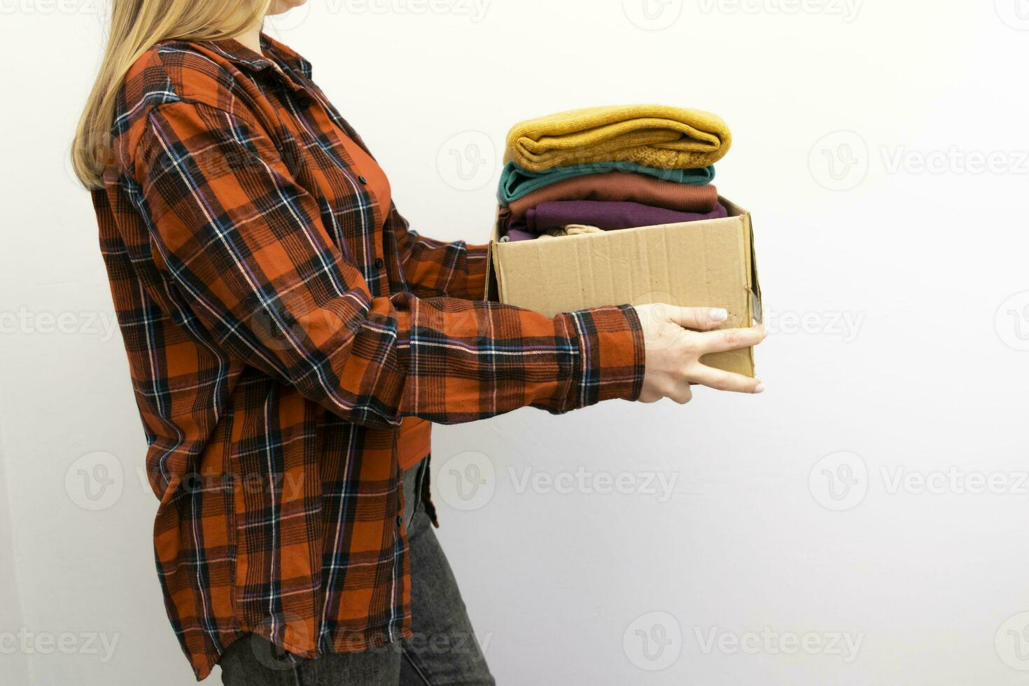 Woman packs clothes in boxes for donating. 23746077 Stock Photo at Vecteezy