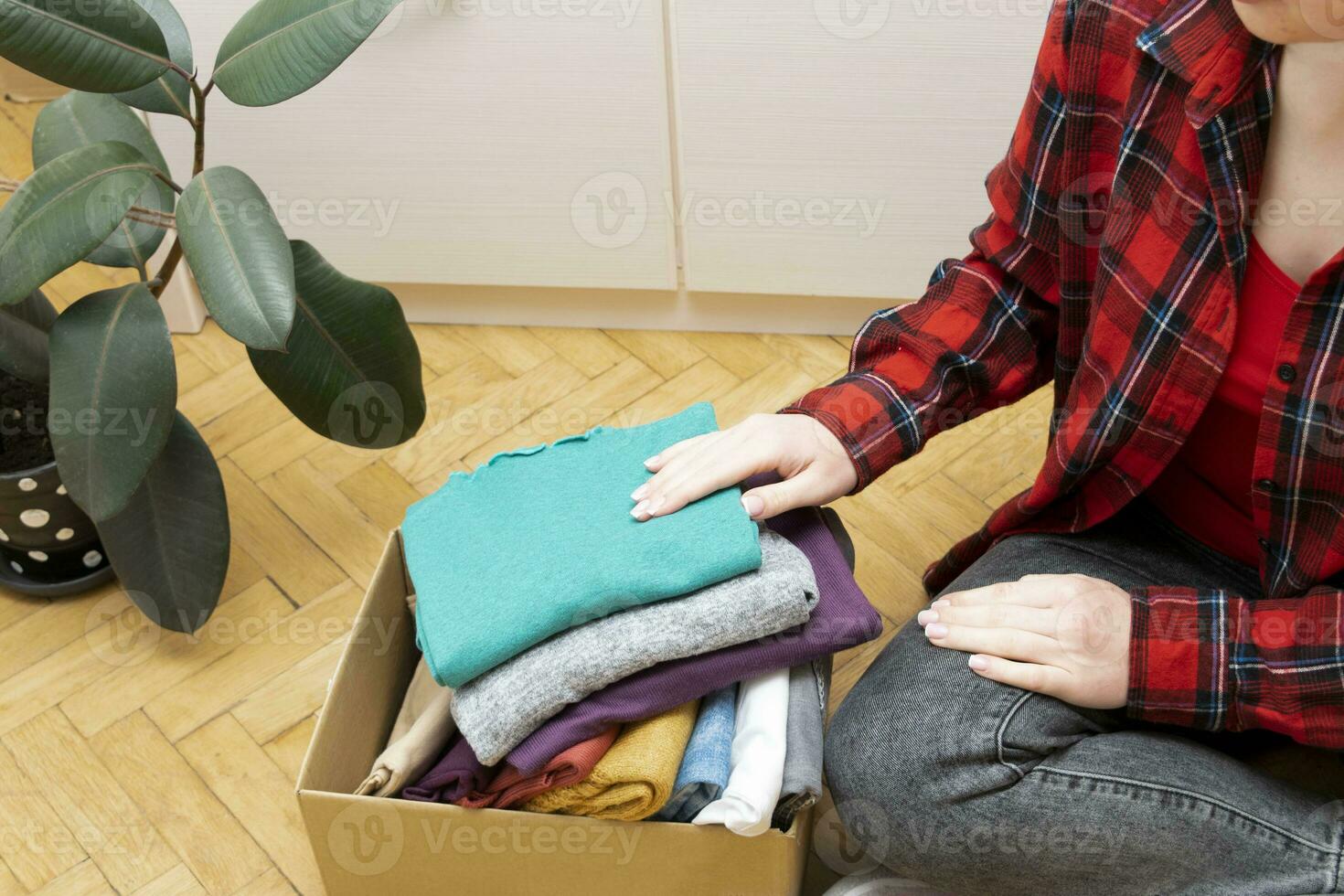 Woman packs clothes in boxes for donating. 23746084 Stock Photo at Vecteezy