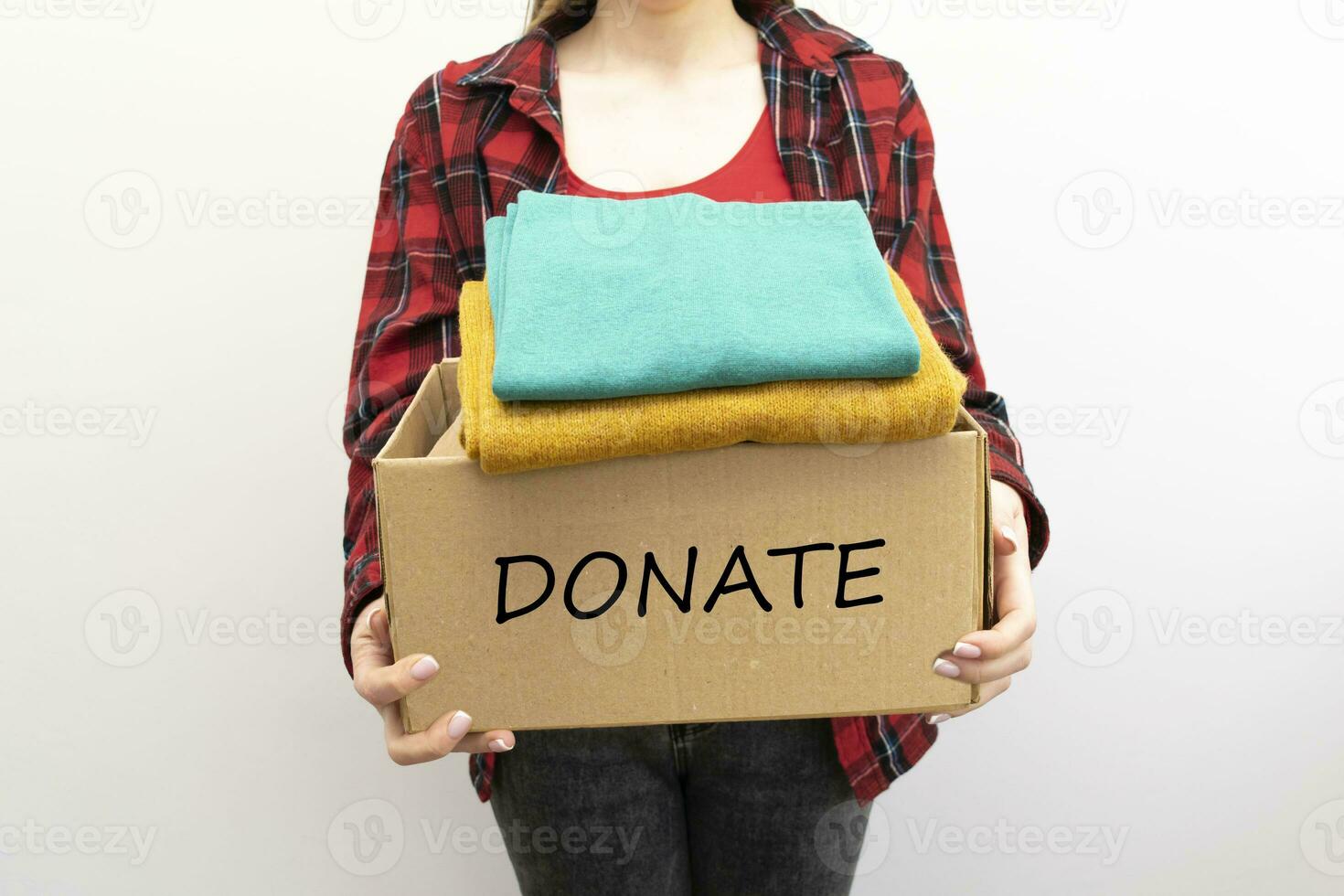 Woman packs clothes in boxes for donating. photo