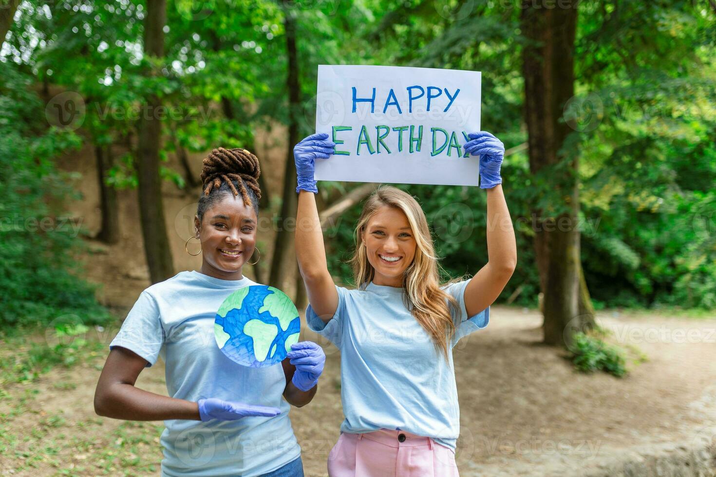 Happy Earth day. People cleaning up litter on grass. Group of international young people building team outdoor in park. Volunteer together pick up trash in the park photo